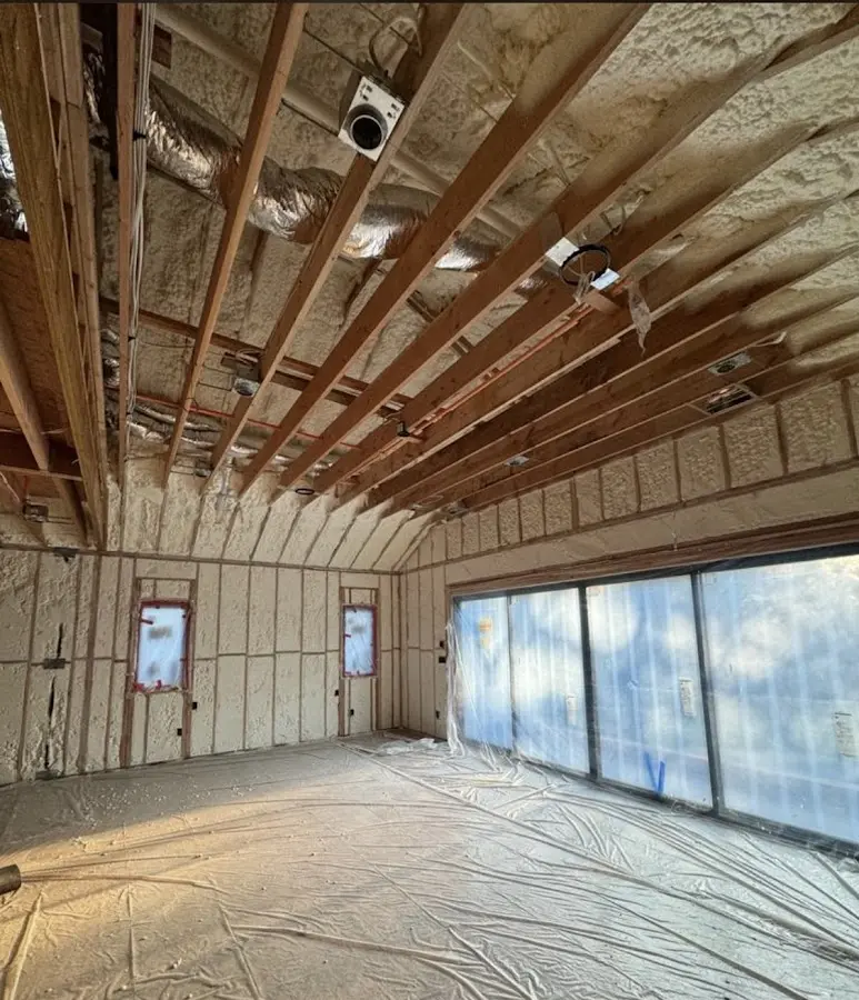 Interior walls and ceiling insulated with spray foam during new construction in Newstead
